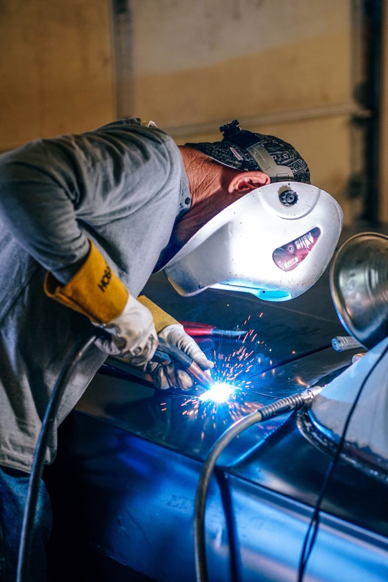 welding professional working on a car