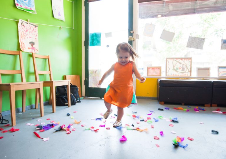 a young preschooler dancing at school