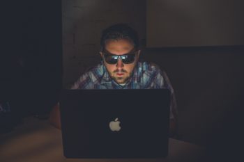 a man working on his laptop at night