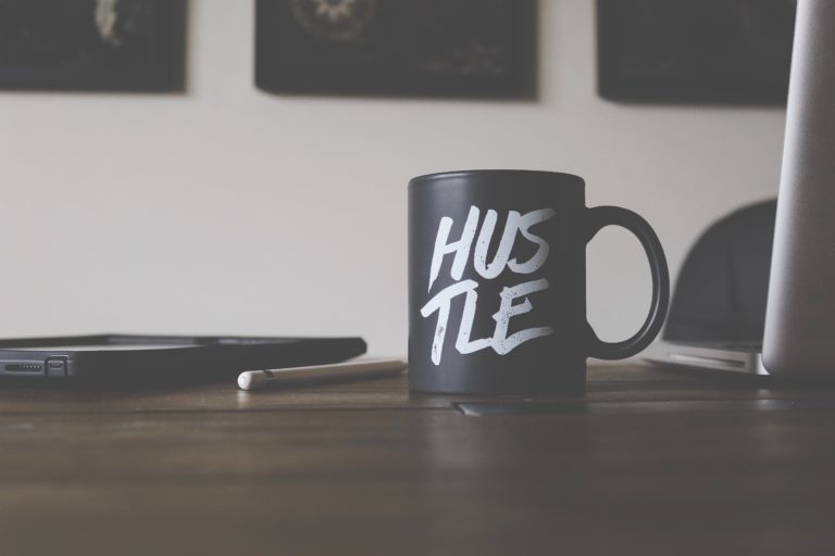 a coffee cup that says hustle